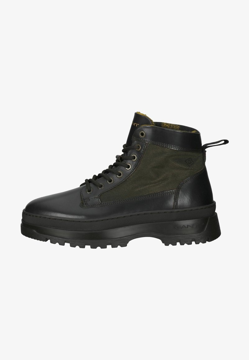 Schwarze Leder- und olivgrüne Stoff-Ankelstiefel mit robuster Sohle, Schnürung vorne und Zuglasche hinten. Mit strukturierter Oberfläche und Logodetails.