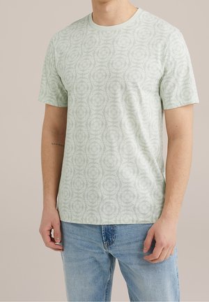 Lichtgroene T-shirt met korte mouwen en een cirkelvormig bloemenpatroon. Gemaakt van zachte stof, met een ronde hals en een reguliere pasvorm.