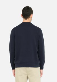 Navyblaues Sweatshirt aus Baumwollmischung, mit Rundhalsausschnitt, langen Ärmeln, gerippten Bündchen und Saum sowie einer glatten Textur.