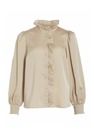 Beige bluse med rynket krave og foran, lange puffede ærmer, smockede manchetter og knaplukning. Fremstillet af glat, blødt stof.