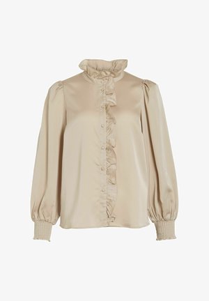 Beige blouse met ruches kraag en voorkant, lange pofmouwen, smockmanchetten en knoopsluiting. Gemaakt van een gladde, zachte stof.