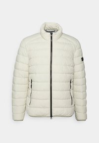 Giacca puffer leggera color crema con zip anteriore, colletto rialzato, motivo trapuntato diagonale e dettagli in zip e accentuazione nera.
