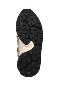 Suola in gomma nera con un motivo di trazione a quadrati e creste; lati adornati con un materiale cremoso a pois.