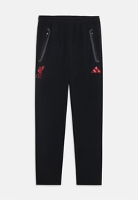 Čierne športové nohavice s elastickým pásom, so zipsovými bočnými vreckami, zdobené červenými logami Liverpool FC a Adidas. Hladký materiál, úzky strih.