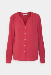 Blusa rossa con maniche lunghe, scollatura a V e chiusura con bottoni davanti. Realizzata in tessuto leggero con una texture liscia e una leggera lucentezza.