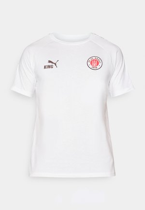 Valge lühikeste varrukatega t-särk, mis on valmistatud siledast kangast. Rinnal on punane ja must ringikujuline logo, samuti pruuni värvi PUMA ja KING brändingu detailid.