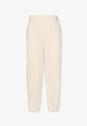 Beige hoch taillierte Hose mit Reißverschluss, Seitentaschen und schmal zulaufender Naht am Knöchel.