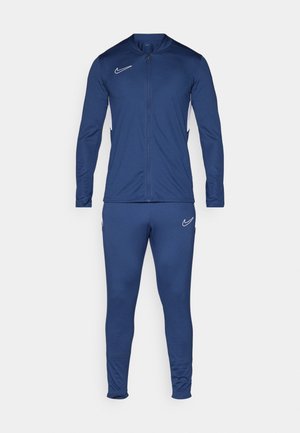 Navy blue athletic tracksuit made of smooth, stretchy fabric, featuring a zip-up jacket with a stand collar and matching fitted pants.
