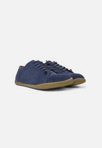 Navy suede lace-up shoes with a soft texture, rounded toe, and flexible tan rubber sole. Features understated stitching and a simple design.