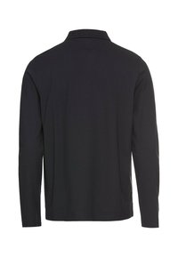 Polo noir à manches longues avec col côtelé, vu de dos sur fond blanc.