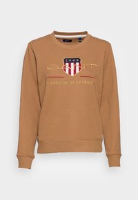 Brauner Pullover aus Baumwolle mit Rundhalsausschnitt, gerippten Bündchen und Saum sowie einem zentralen Logo mit Schild-Design und dem Text "GANT 1949 AMERICAN SPORTSWEAR".