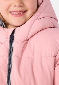 Pink puffer jacket with a high collar, featuring a contrasting navy zipper and striped interior lining. Smooth texture with visible stitching.