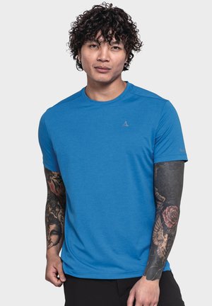 Short-sleeve athletic shirt in bright blue, featuring a textured pattern and a small logo on the chest. Black pants partially visible.