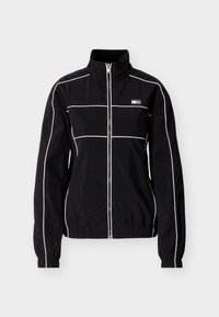 Μαύρο ελαφρύ μπουφάν με ψηλό γιακά, κλείσιμο με φερμουάρ και λευκά διακοσμητικά περιθώρια. Διαθέτει ελαστικά μανίκια και μαρκάρισμα με λογότυπο στο στήθος.