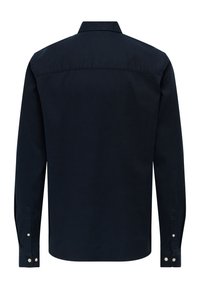 Majica z dolgimi rokavi iz temno modrega bombažnega blaga. Ima koničast ovratnik, zapestne manšete z gumbi in šiv na zadnji yoke za strukturo.