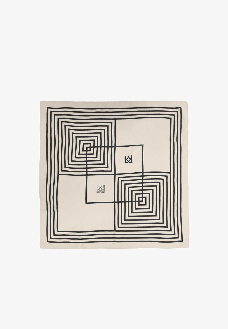 Pătură din bumbac bej cu model geometric spiral negru. Prezintă pătraturi centrate cu grosimi de linie variate și două accente cu logo.