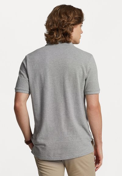 Gray short-sleeve polo shirt with a classic collar, made of textured cotton blend fabric, featuring a straight hem and rolled cuffs.