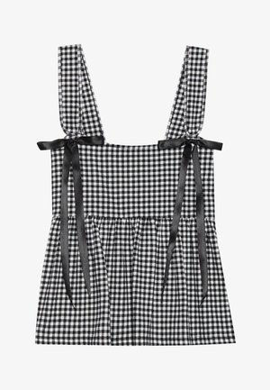 Svart og hvit gingham topp med brede stropper, med svarte satengbånd og en volangkant. Laget av bomullblanding.