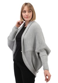 Grijze geribde cardigan met brede mouwen en een relaxte pasvorm, voorzien van een sjawlboord en voorzakken. Zachte, gestructureerde gebreide stof.