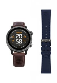 Digitale horloge met een zwarte behuizing, een bruine leren band en een marineblauwe siliconen band. Heeft een rond display met grote digitale cijfers en iconen.
