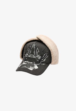 Black cap with a denim texture, featuring a fuzzy tan ear flap, printed eagle design, and the year "1971" in gray.