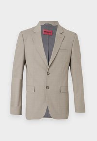 Μπεζ σακάκι με δύο κουμπιά, καλλιεργημένες πέτες και μία τσέπη στο στήθος. Επενδυμένο με γκρι ύφασμα. Υποτονική υφαντή υφή.