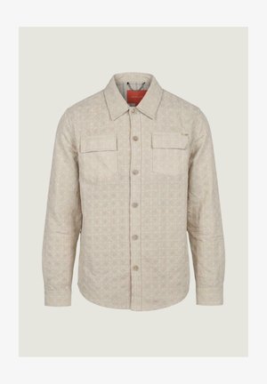 Giacca beige chiaro con bottoni, motivo trapuntato a diamante, due tasche con patta sul petto e colletto appuntito.