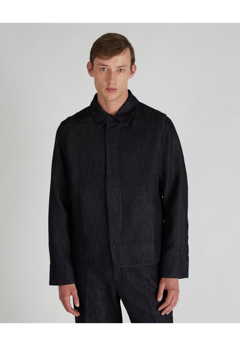 Dark denim jacket with a collared neck, front placket, and long sleeves. Fabric is textured and slightly brushed for a casual look.