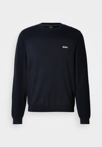 Pull bleu marine à manches longues col rond avec poignets et ourlet côtelés, avec un petit logo blanc "BOSS" sur le côté gauche de la poitrine.