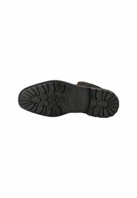 Semelle de chaussure en caoutchouc noir avec un motif de texture, crampons hexagonaux pour une meilleure adhérence, et nom de la marque en relief. Forme plate et arrondie conçue pour la stabilité.
