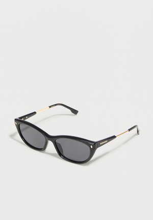 Black cat-eye sunglasses with dark lenses and thin gold arms, branded with "DSQUARED2" on the temple.