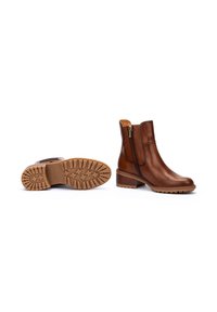 Braune Leder-Ankle-Boots mit seitlichem Reißverschluss, strukturiertem Gummiaußensohle und niedrigem gestapeltem Absatz. Glatte Oberfläche mit kontrastierenden Akzenten.