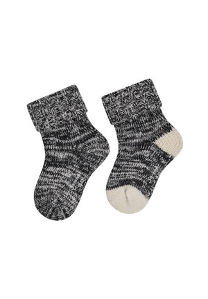 Pair of black and white knitted baby socks with folded cuffs, one sock has a white toe and heel patch.