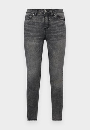 Zwarte skinny jeans van denim, met een vervaagde afwerking, traditionele vijf-pocket stijl en rafel details bij de enkels.