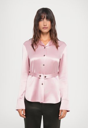 Light pink satin shirt with a collar, long sleeves, and a belted waist. Features button details along the front and a smooth, glossy texture.