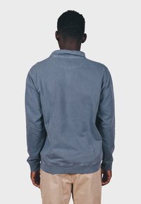 Pullover sweatshirt i lys blå bomuld, med krave og ribbede manchetter. Enkel design med glat tekstur og diskret søm.