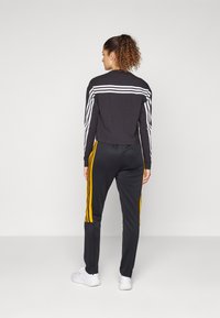 adidas Sportswear TIRO CUT 3 STRIPES TRACKPANTS - Treniņtērpa apakšdaļas - black/crew orange