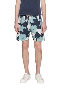 Navyblauwe zwembroek met een groot, licht turquoise en wit bloemenpatroon. Gemaakt van lichte stof met een elastische tailleband en een trekkoord.