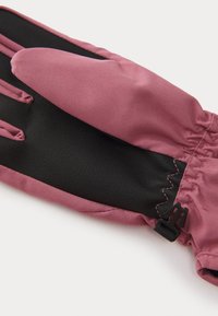 Pink and black winter glove with textured black palm, smooth pink fabric upper, elastic wrist, and snap closure detail at the cuff.