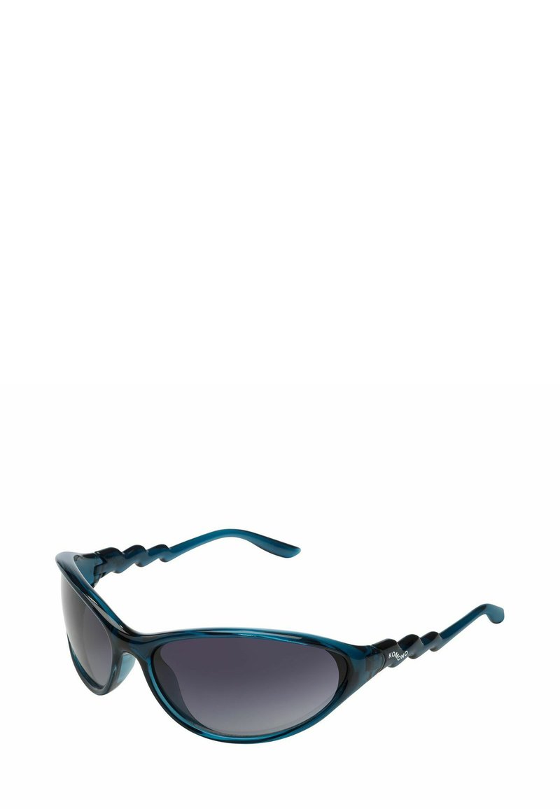 Lunettes de soleil avec une monture vert foncé, en forme d'œil de chat, et des verres dégradés. Design ondulé distinctif sur les branches, texture lisse.