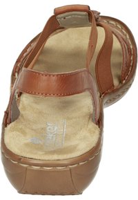 Brown leather sandal with tan textile straps, soft cushioned insole, and a rounded toe. Features visible stitching and a small buckle.