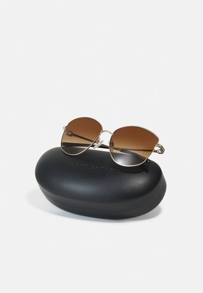 Sunglasses with round brown lenses in a gold metal frame, resting on a black oval protective case embossed with "RALPH LAUREN."