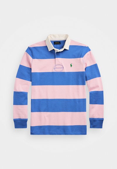 Hosszú ujjú pólóing kék és rózsaszín csíkokkal, fehér gallérral és zöld logóval a bal mellrészen. Pamutból készült, bordázott mandzsettákkal.