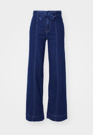 Wide-leg dark denim jeans with a high waist, featuring a front tie belt and contrasting stitching along side seams and hems.