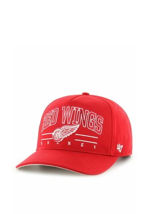 Red baseball cap, red fabric, embroidered "RED WINGS" text in white, wing logo, adjustable strap at back, curved visor.