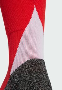Red, pink, and gray patterned sock with a color-blocked design. Features a ribbed texture and smooth fabric, highlighted by sharp triangular shapes.
