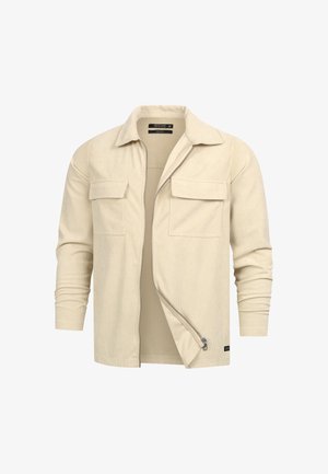 Beige kordfløyeljakke med to brystlommer og åpen glidelås, vist mot en hvit bakgrunn.