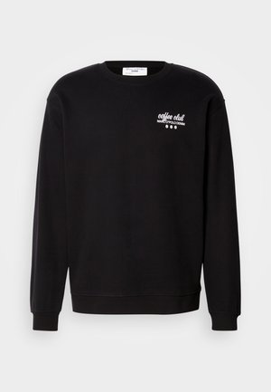 Sweat-shirt noir en coton, avec un col rond, des manches longues et un logo graphique blanc sur la zone gauche de la poitrine.