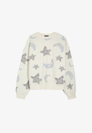 Valge sviiter, millel on halli värvi tähe ja poolkuu muster ning õrn hõbedane detail. Lõdva istuvuse ja soonikustega mansetid.