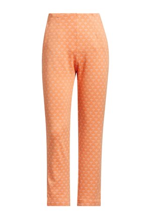Pomarańczowe legginsy z małym wzorem białych serc. Wykonane z elastycznego materiału, o gładkiej fakturze i dopasowanym kroju.